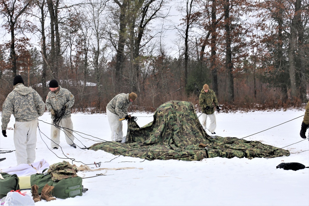 Cold-Weather Operations Course Class 20-01 students build Arctic tents during training at Fort McCoy