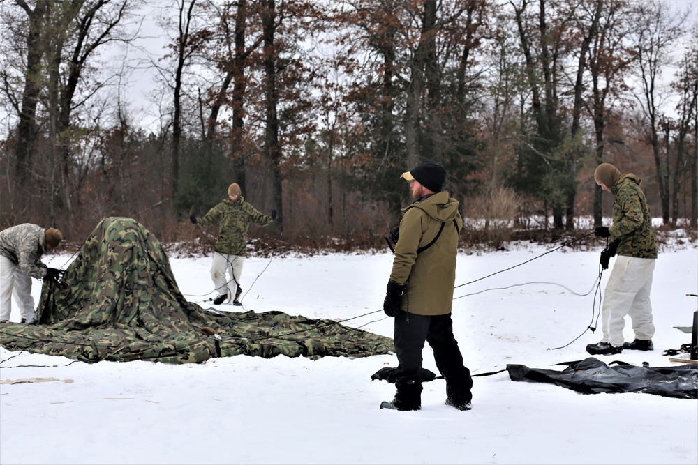 Cold-Weather Operations Course Class 20-01 students build Arctic tents during training at Fort McCoy