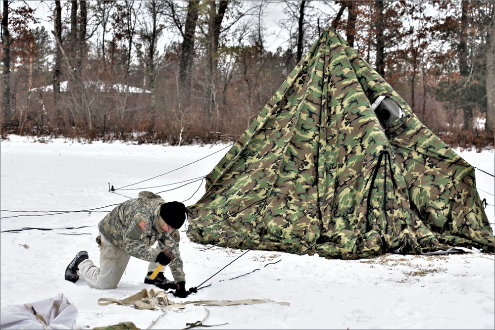 Cold-Weather Operations Course Class 20-01 students build Arctic tents during training at Fort McCoy