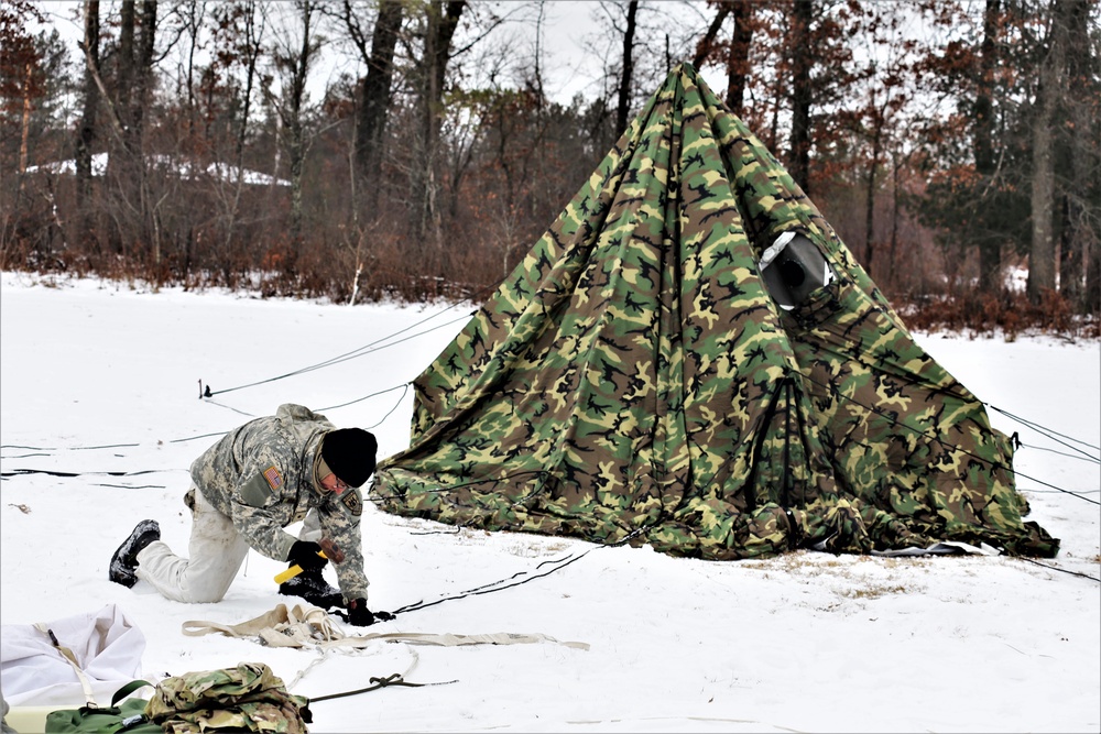 Cold-Weather Operations Course Class 20-01 students build Arctic tents during training at Fort McCoy