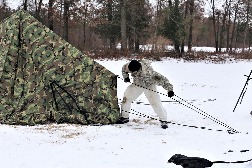 Cold-Weather Operations Course Class 20-01 students build Arctic tents during training at Fort McCoy