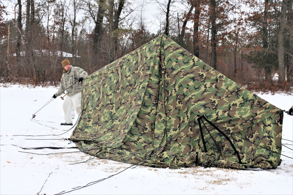 Cold-Weather Operations Course Class 20-01 students build Arctic tents during training at Fort McCoy