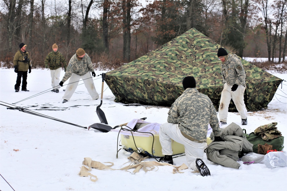 Cold-Weather Operations Course Class 20-01 students build Arctic tents during training at Fort McCoy