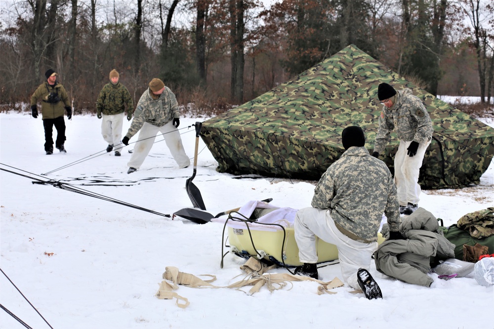 Cold-Weather Operations Course Class 20-01 students build Arctic tents during training at Fort McCoy