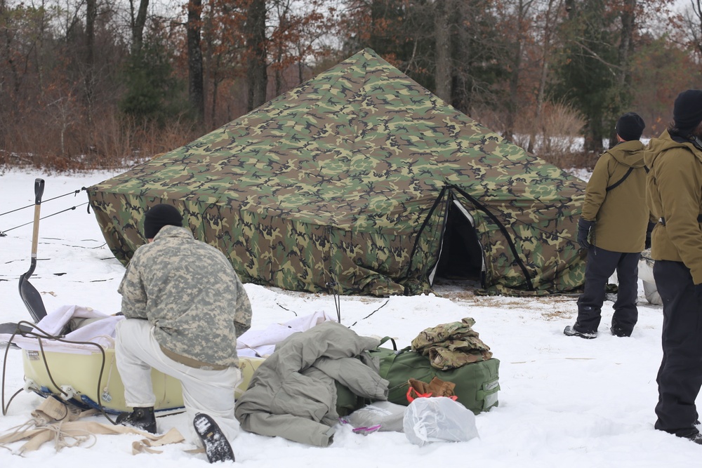 Cold-Weather Operations Course Class 20-01 students build Arctic tents during training at Fort McCoy