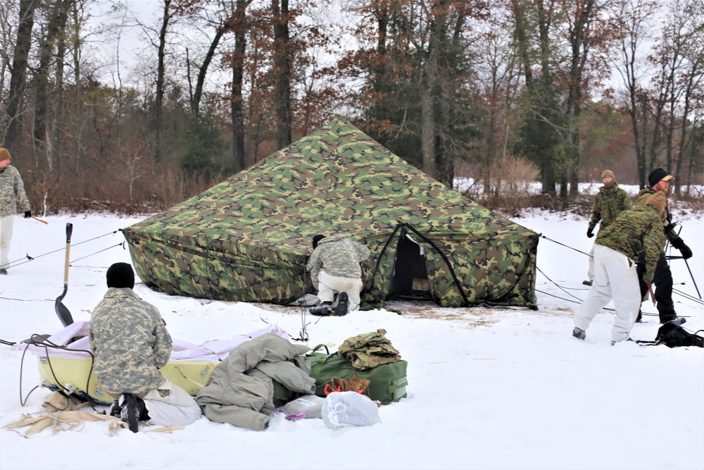 Cold-Weather Operations Course Class 20-01 students build Arctic tents during training at Fort McCoy