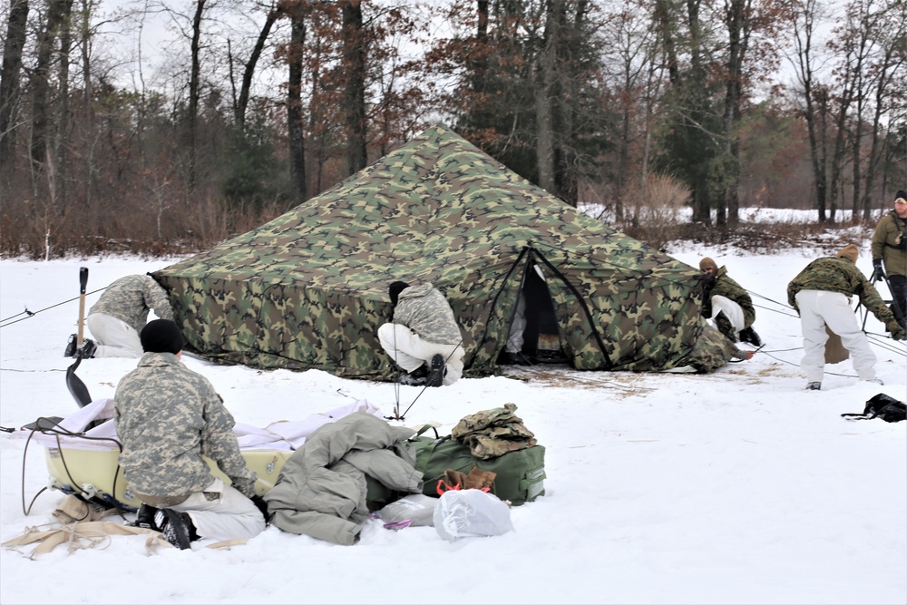 Cold-Weather Operations Course Class 20-01 students build Arctic tents during training at Fort McCoy
