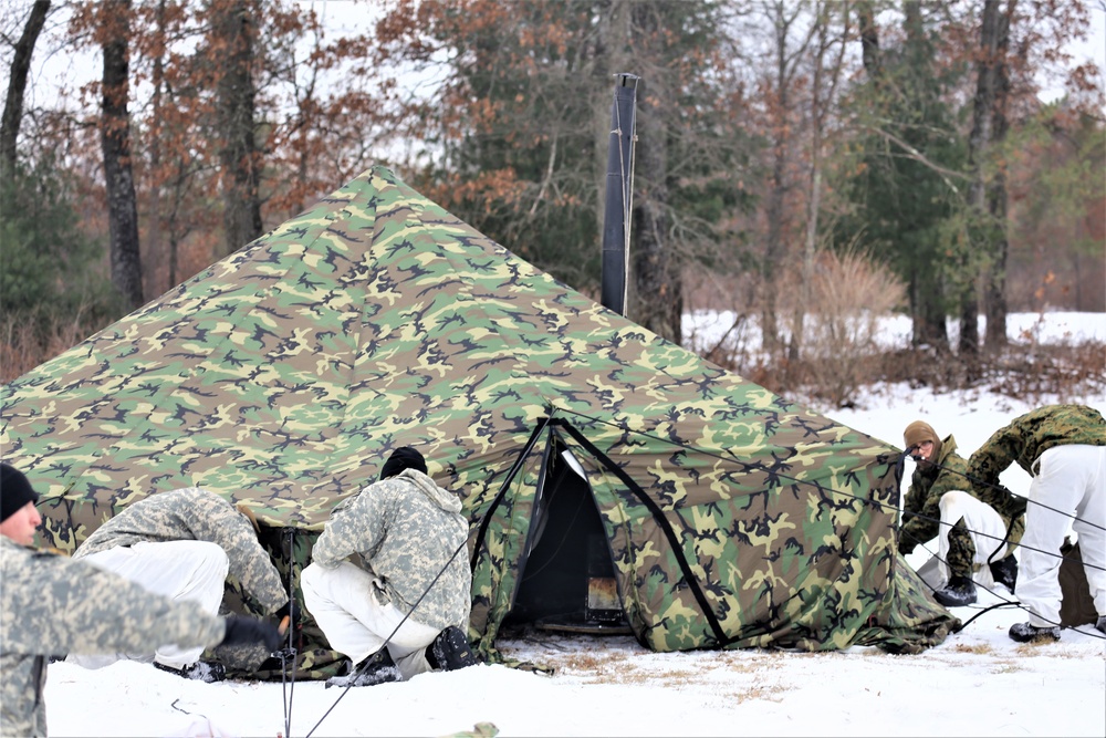 Cold-Weather Operations Course Class 20-01 students build Arctic tents during training at Fort McCoy