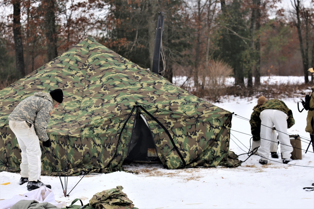 Cold-Weather Operations Course Class 20-01 students build Arctic tents during training at Fort McCoy