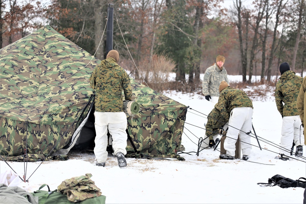 Cold-Weather Operations Course Class 20-01 students build Arctic tents during training at Fort McCoy