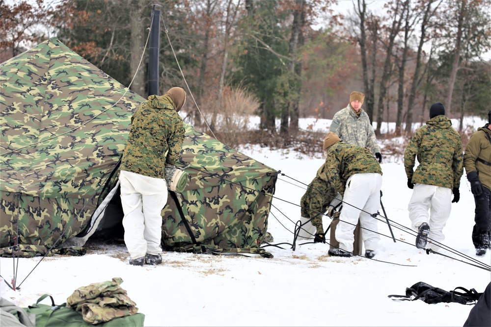 Cold-Weather Operations Course Class 20-01 students build Arctic tents during training at Fort McCoy