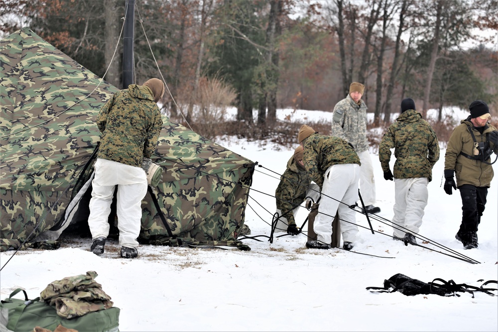 Cold-Weather Operations Course Class 20-01 students build Arctic tents during training at Fort McCoy