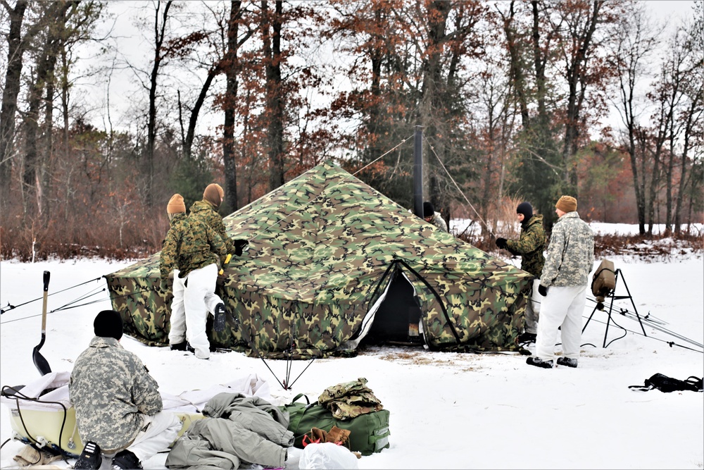 Cold-Weather Operations Course Class 20-01 students build Arctic tents during training at Fort McCoy