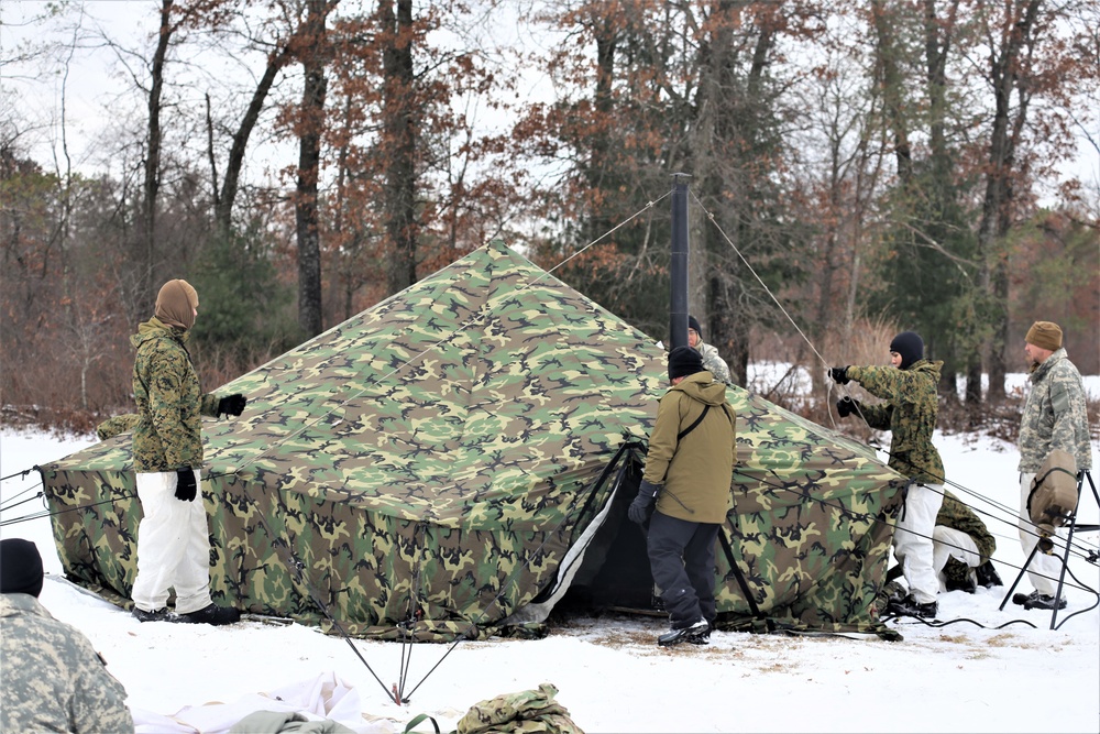 Cold-Weather Operations Course Class 20-01 students build Arctic tents during training at Fort McCoy