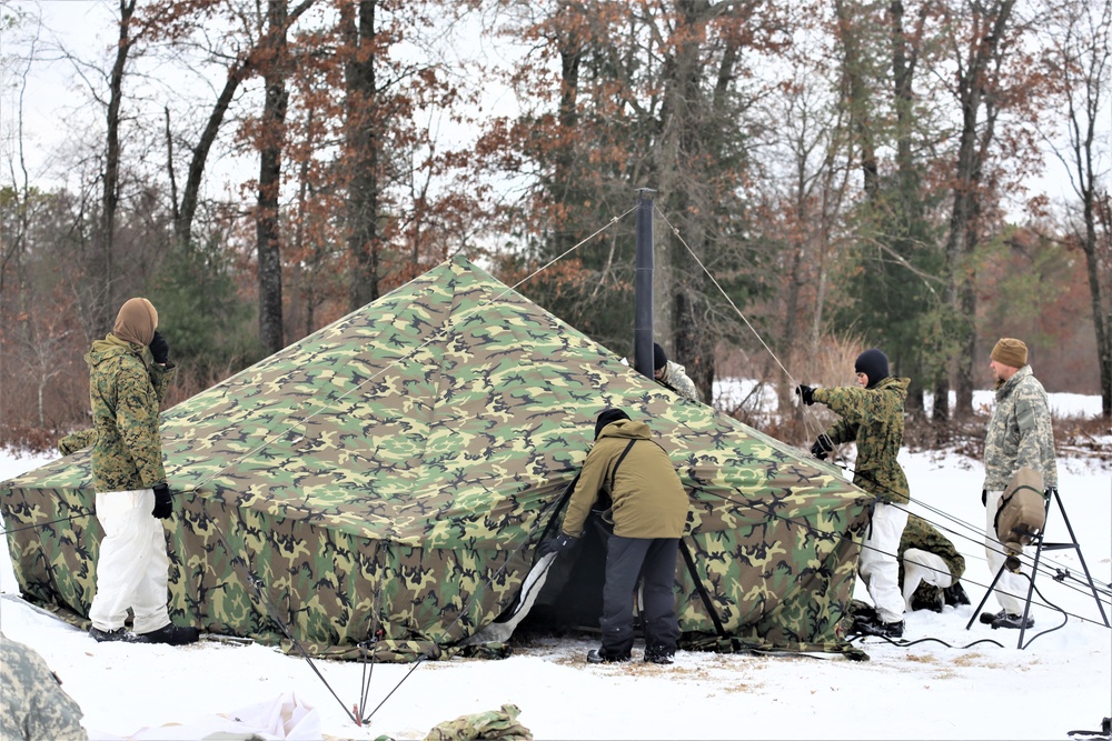 Cold-Weather Operations Course Class 20-01 students build Arctic tents during training at Fort McCoy