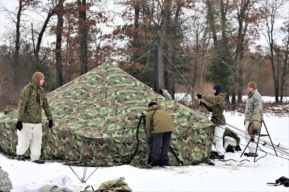 Cold-Weather Operations Course Class 20-01 students build Arctic tents during training at Fort McCoy