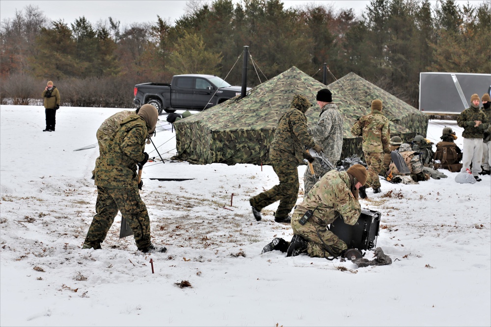 Cold-Weather Operations Course Class 20-01 students build Arctic tents during training at Fort McCoy