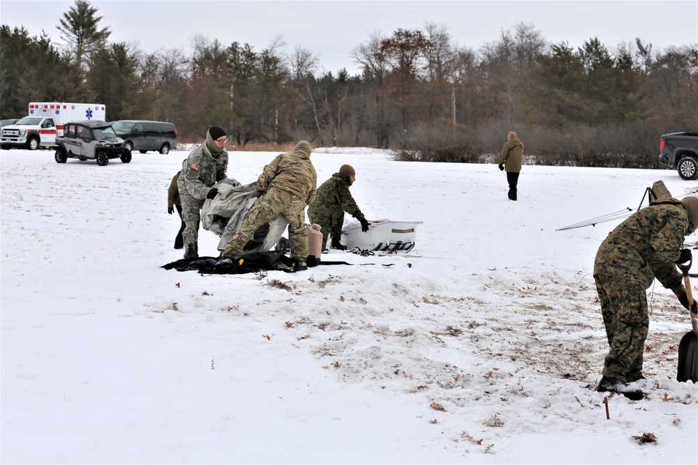 Cold-Weather Operations Course Class 20-01 students build Arctic tents during training at Fort McCoy