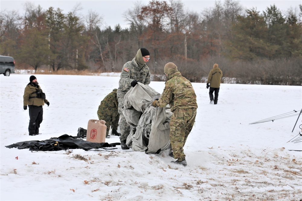 Cold-Weather Operations Course Class 20-01 students build Arctic tents during training at Fort McCoy