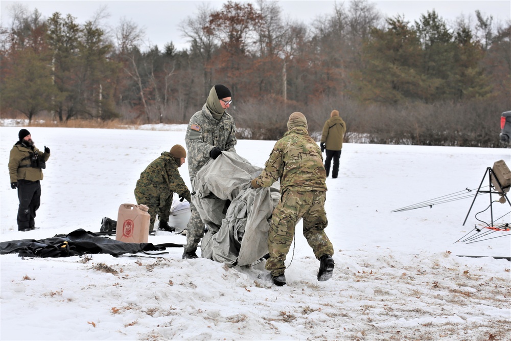 Cold-Weather Operations Course Class 20-01 students build Arctic tents during training at Fort McCoy
