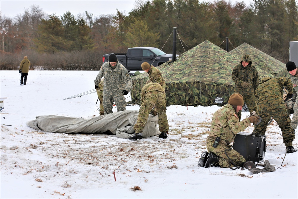 Cold-Weather Operations Course Class 20-01 students build Arctic tents during training at Fort McCoy