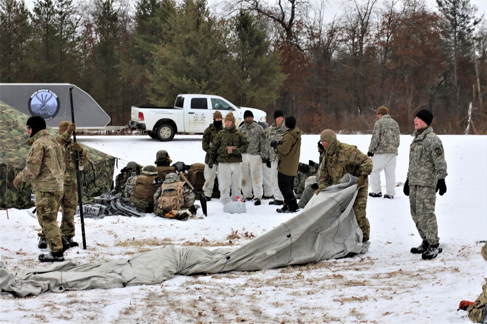 Cold-Weather Operations Course Class 20-01 students build Arctic tents during training at Fort McCoy