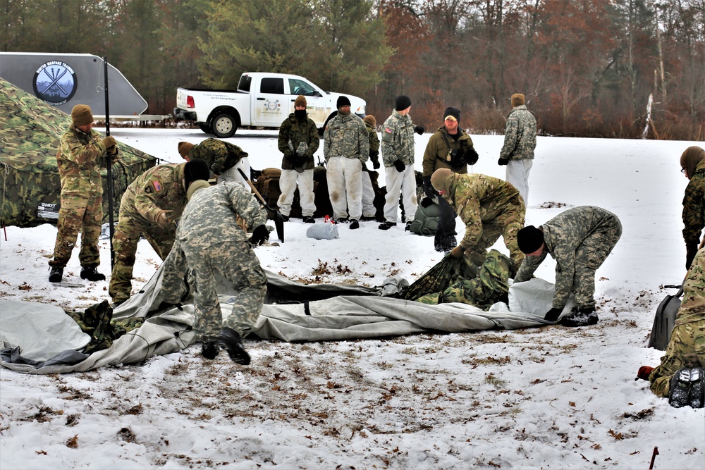 Cold-Weather Operations Course Class 20-01 students build Arctic tents during training at Fort McCoy