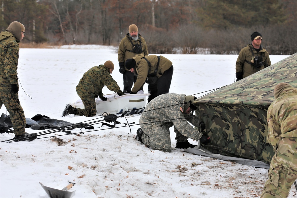 Cold-Weather Operations Course Class 20-01 students build Arctic tents during training at Fort McCoy