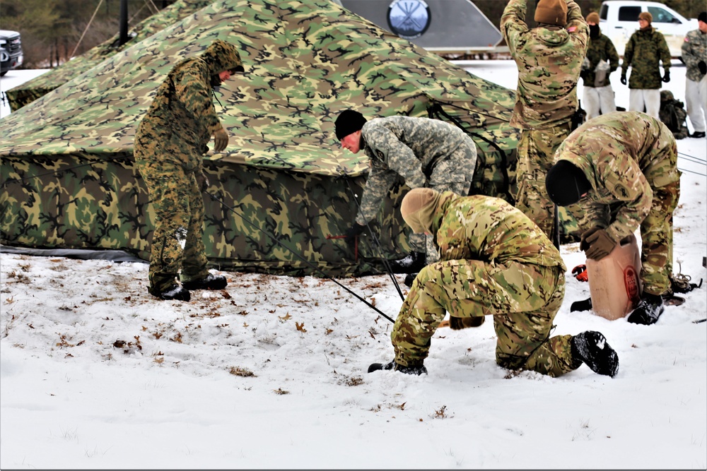 Cold-Weather Operations Course Class 20-01 students build Arctic tents during training at Fort McCoy