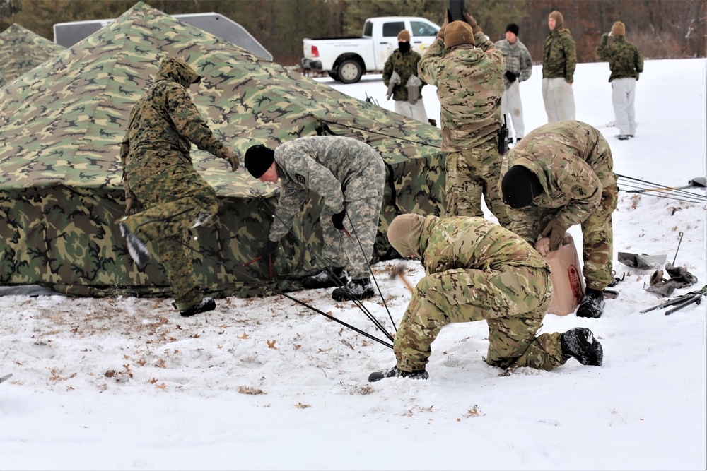 Cold-Weather Operations Course Class 20-01 students build Arctic tents during training at Fort McCoy