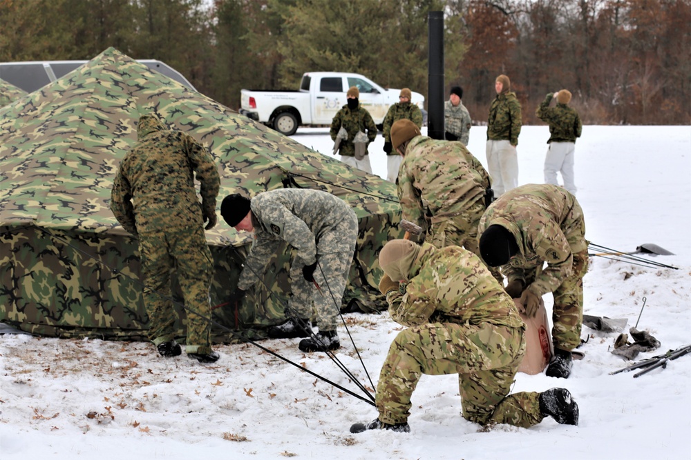 Cold-Weather Operations Course Class 20-01 students build Arctic tents during training at Fort McCoy