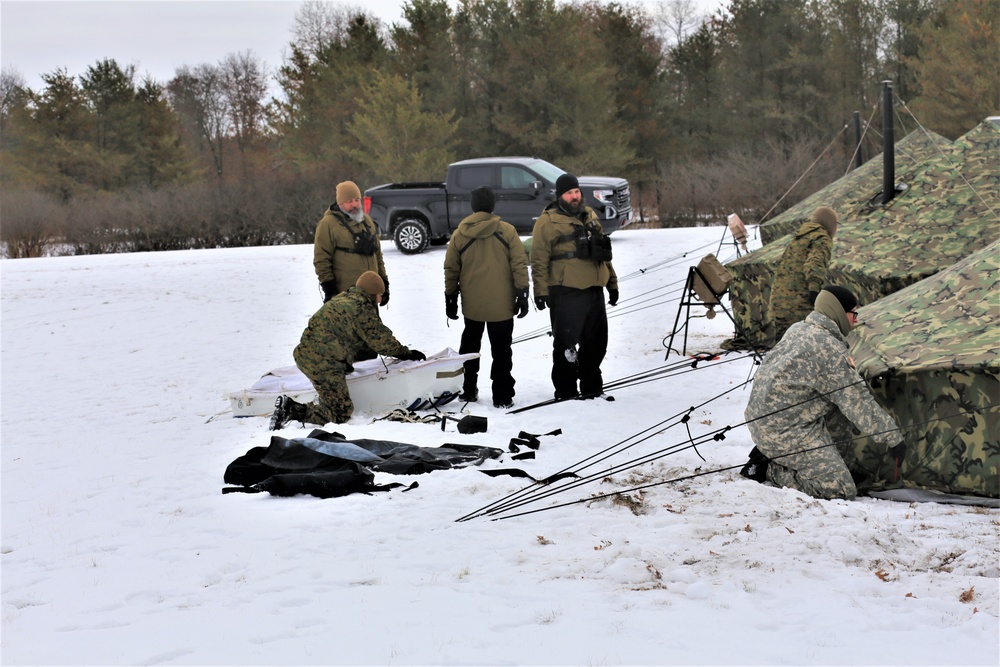Cold-Weather Operations Course Class 20-01 students build Arctic tents during training at Fort McCoy