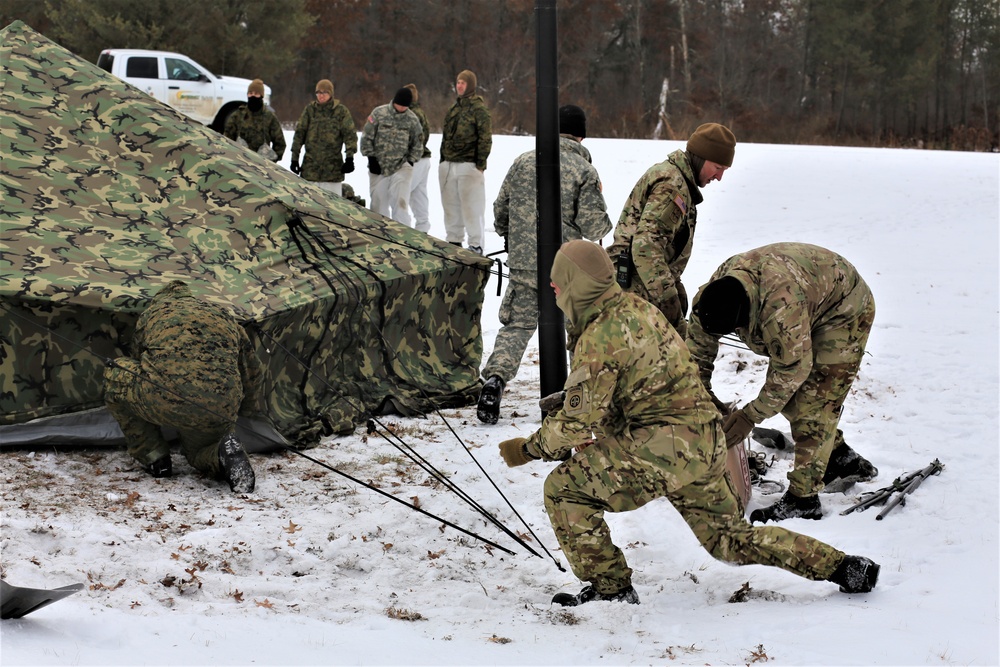 Cold-Weather Operations Course Class 20-01 students build Arctic tents during training at Fort McCoy