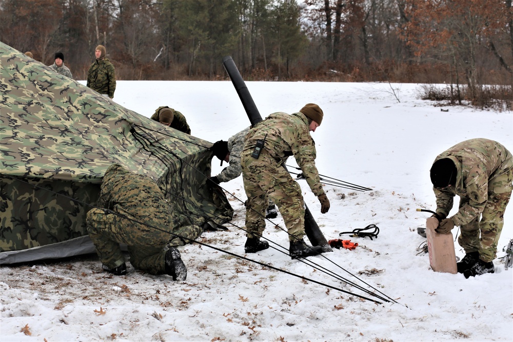 Cold-Weather Operations Course Class 20-01 students build Arctic tents during training at Fort McCoy