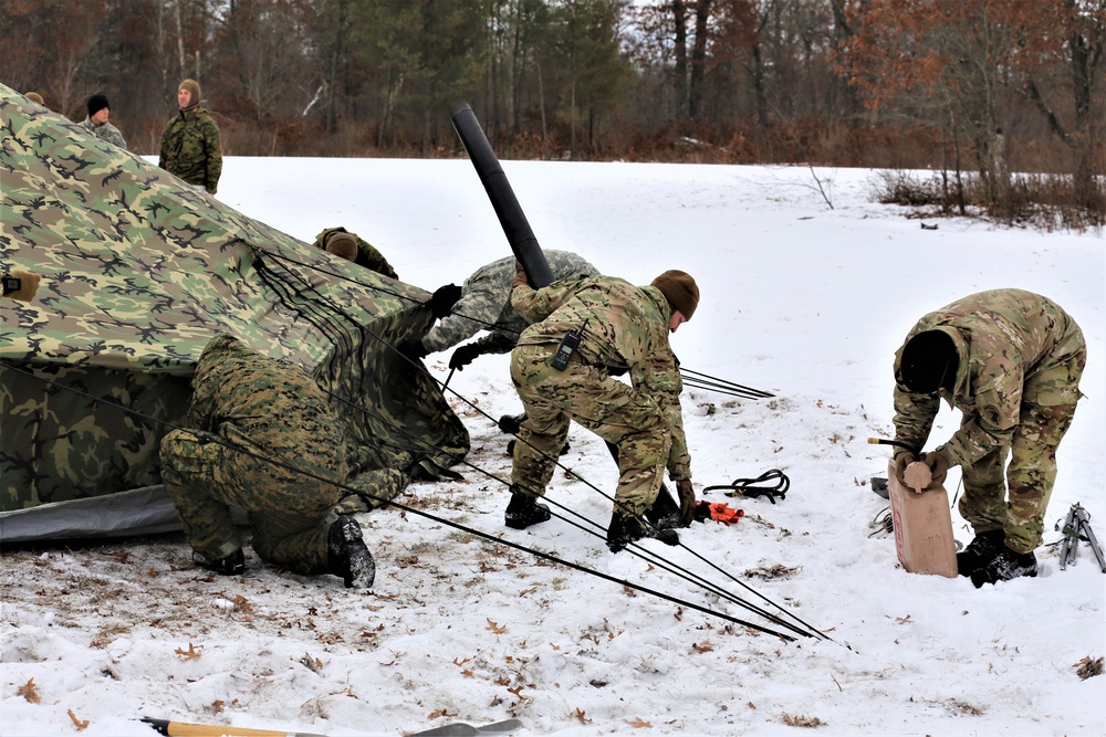 Cold-Weather Operations Course Class 20-01 students build Arctic tents during training at Fort McCoy
