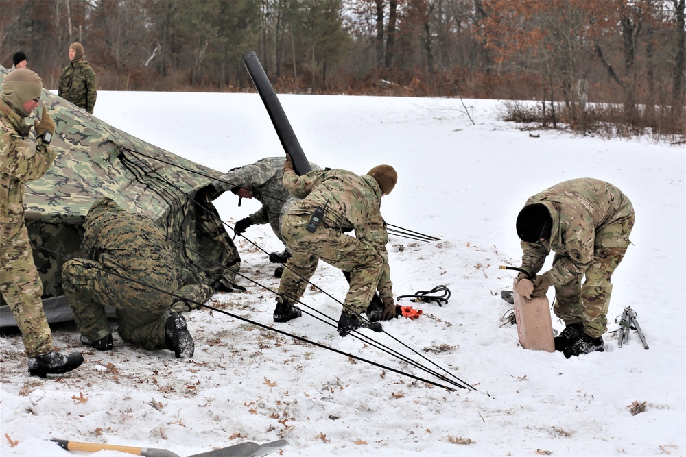 Cold-Weather Operations Course Class 20-01 students build Arctic tents during training at Fort McCoy