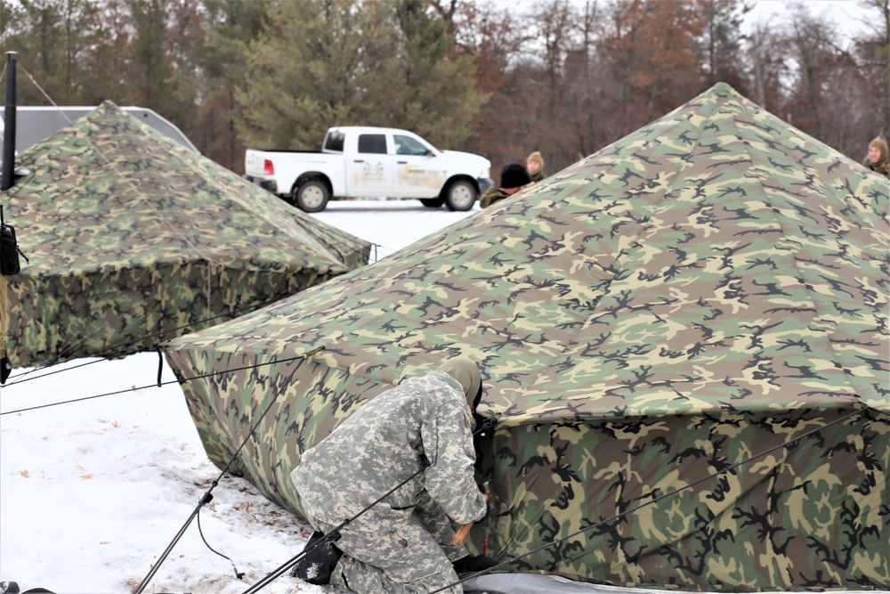 Cold-Weather Operations Course Class 20-01 students build Arctic tents during training at Fort McCoy