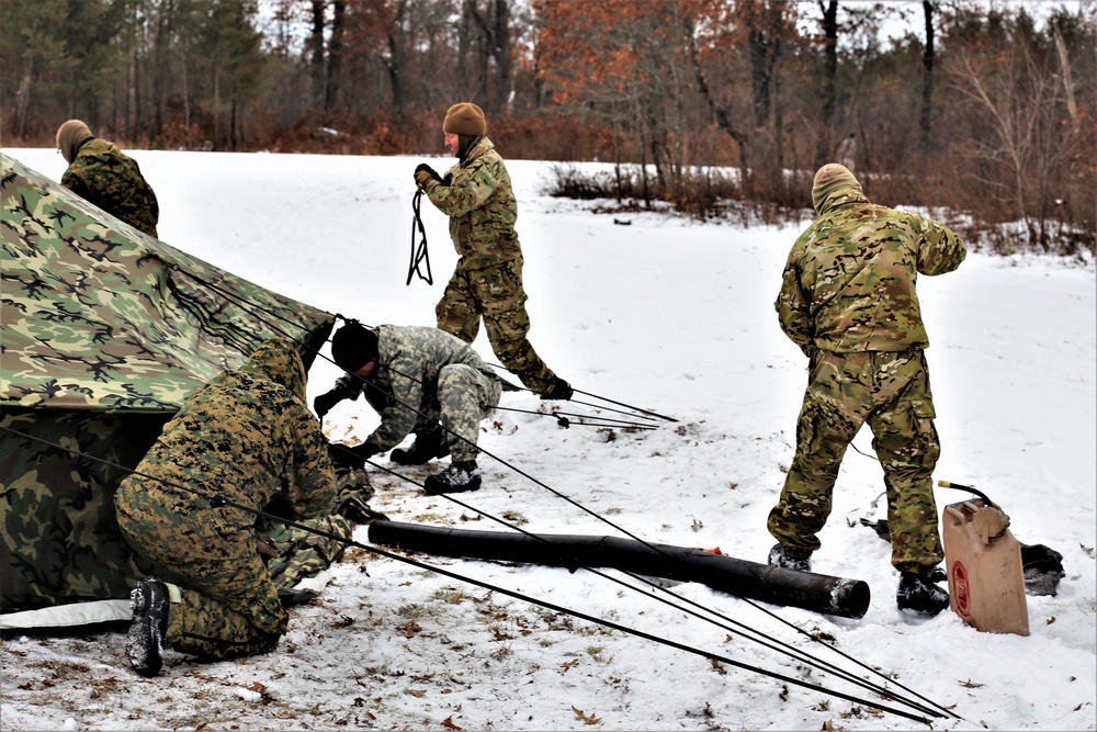 Cold-Weather Operations Course Class 20-01 students build Arctic tents during training at Fort McCoy