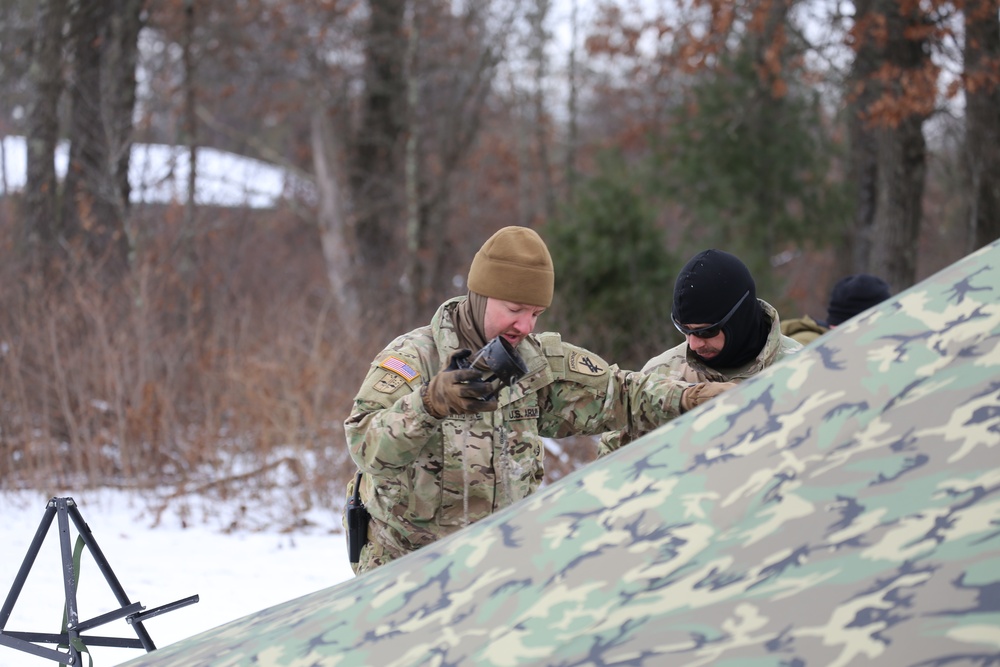 Cold-Weather Operations Course Class 20-01 students build Arctic tents during training at Fort McCoy