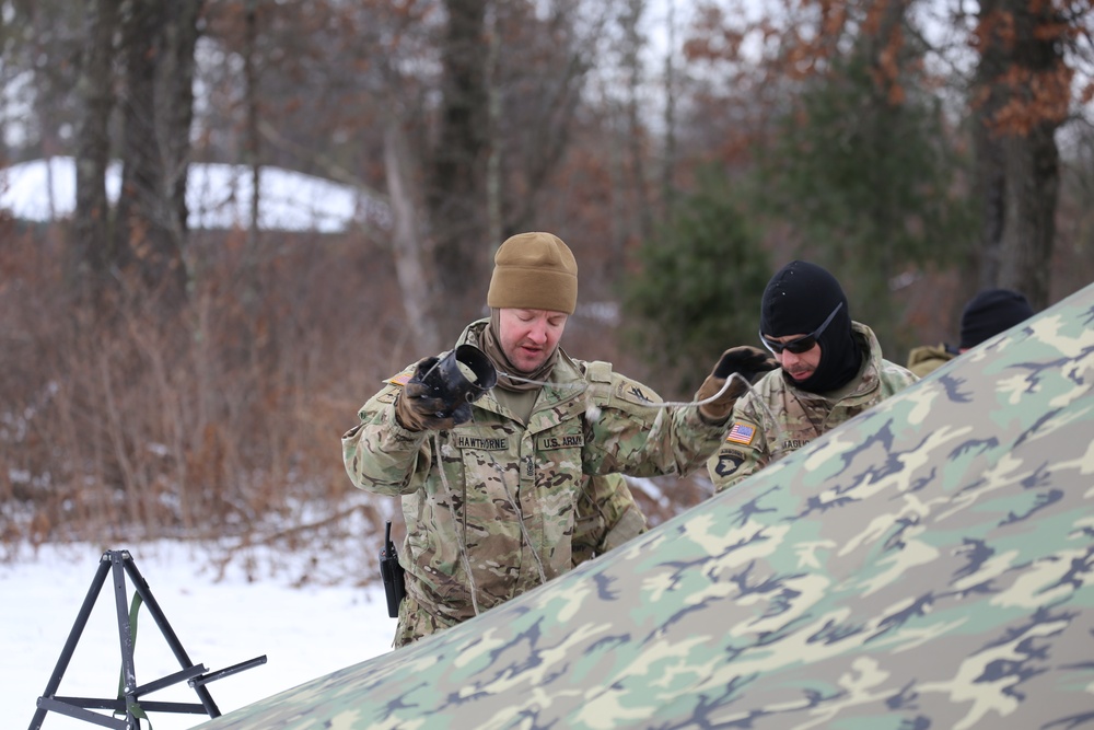 Cold-Weather Operations Course Class 20-01 students build Arctic tents during training at Fort McCoy