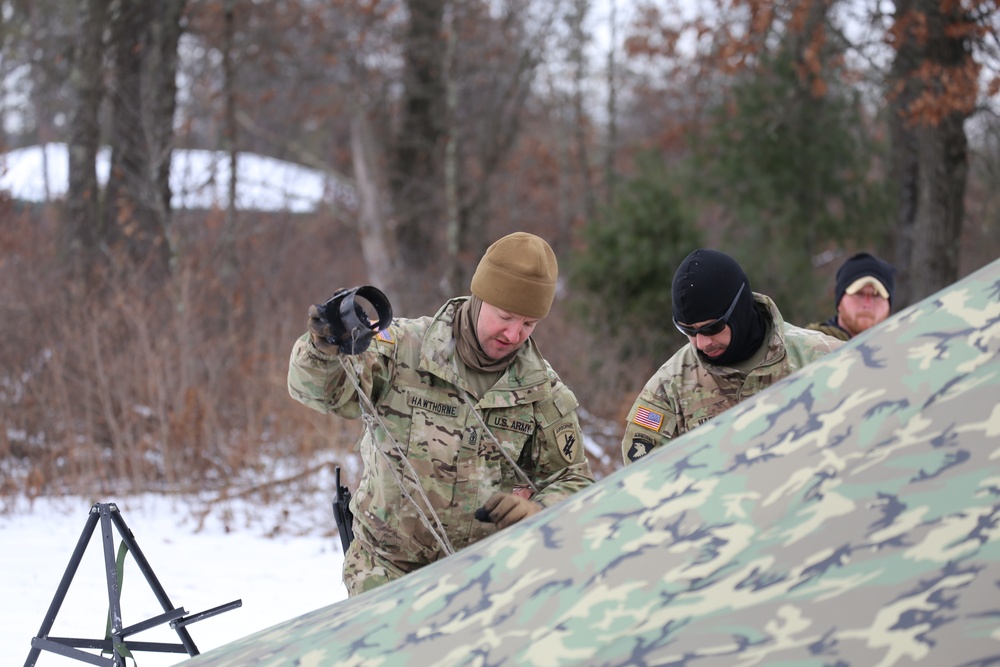Cold-Weather Operations Course Class 20-01 students build Arctic tents during training at Fort McCoy