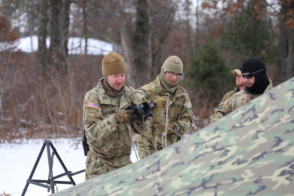 Cold-Weather Operations Course Class 20-01 students build Arctic tents during training at Fort McCoy