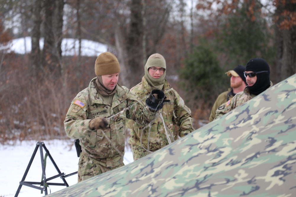 Cold-Weather Operations Course Class 20-01 students build Arctic tents during training at Fort McCoy