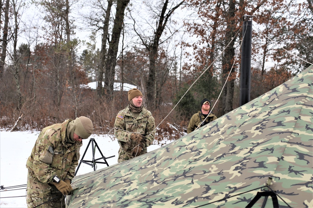 Cold-Weather Operations Course Class 20-01 students build Arctic tents during training at Fort McCoy
