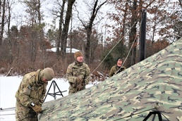 Cold-Weather Operations Course Class 20-01 students build Arctic tents during training at Fort McCoy