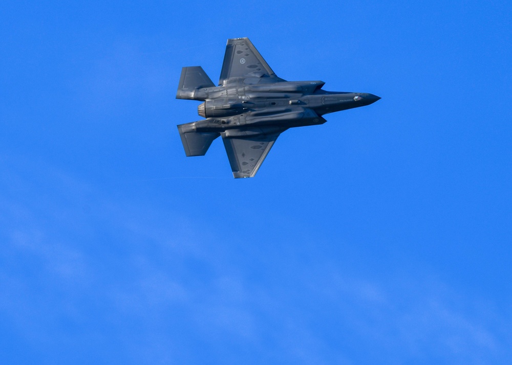 F-35s and F-16s soar in the morning sky