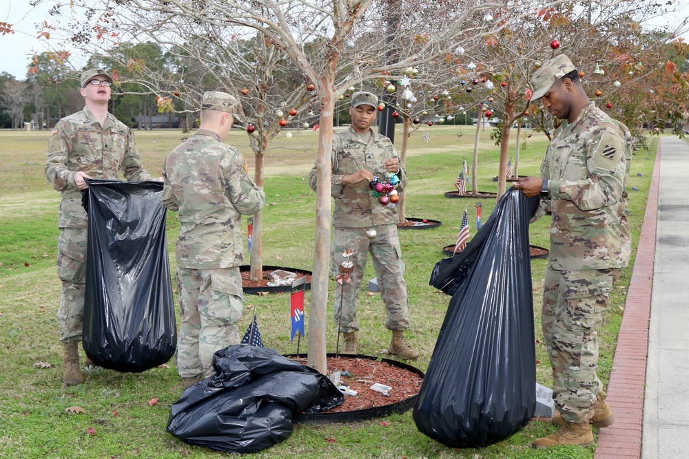 Soldiers and Families clean the trees of Warriors Walk
