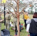 Soldiers and Families clean the trees of Warriors Walk