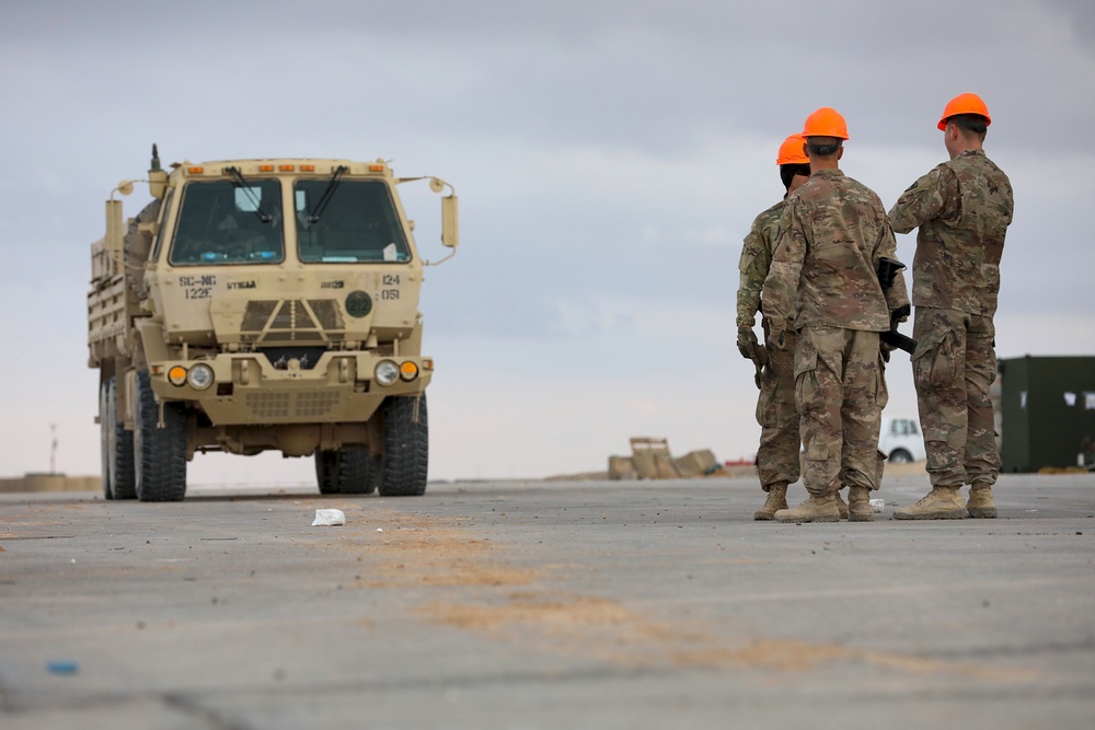 Soldiers, Airmen and contractors clearing debris after Al-Asad Airbase missile attack