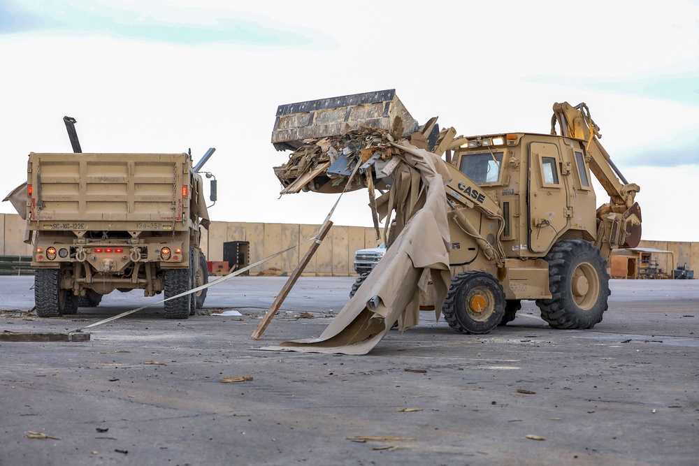 Soldiers, Airmen and contractors clearing debris after Al-Asad Airbase missile attack